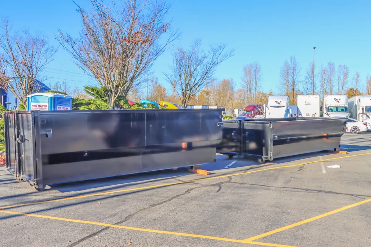 Professional dumpster rental service with roll-off container on residential driveway in Paterson